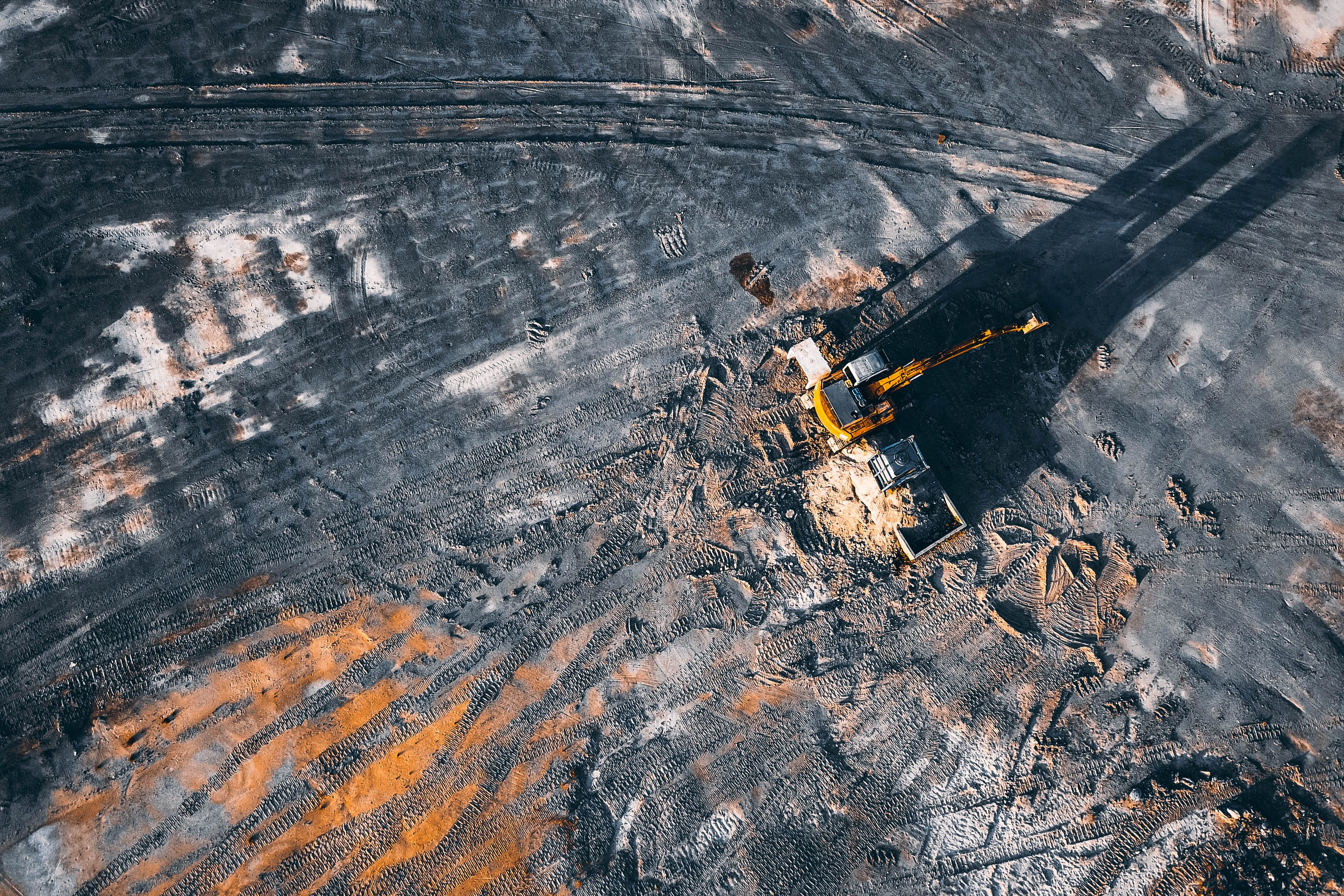 Excavator loading a tipper truck on a Malaysia earthworks site